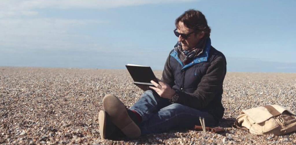 Nial Adams Sketching on Beach
